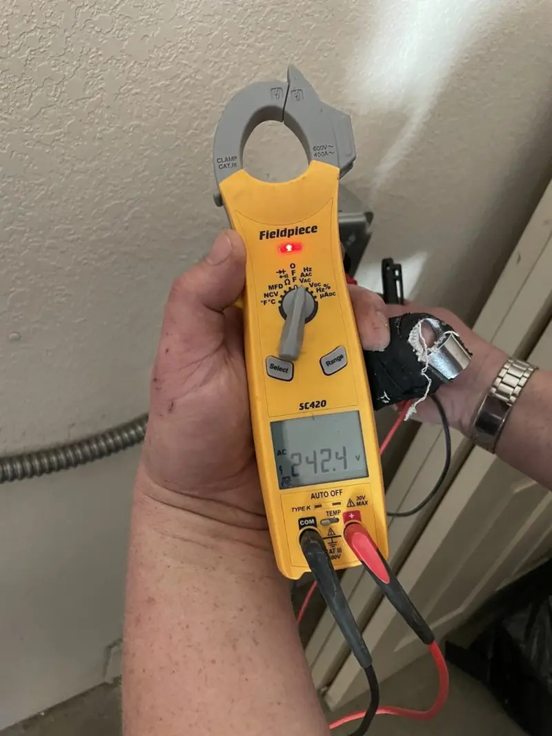 Voltage testing with clamp meter during Electrical Installation Services in West Bend